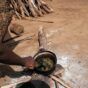 Amjuma Ali cooks Kawal leaves collected from nearby trees at a camp for the displaced people in Kadugli, South Kordofan state, on June 18, 2024, AFP photo