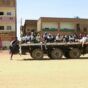 People fleeing street battles between the forces of two rival Sudanese generals, are transported on the back of a truck in the southern part of Khartoum, on April 21, 2023 AFP