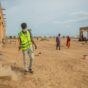 A volunteer sprays the compound and spaces at Alashpal gathering point for displaced persons in West Kassala locality on September 3, 2024 (UNICEF photo)