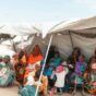 Sudanese displaced women with their children waiting at an MSF dispensary in the White Nile in July 2023 (MSF photo)