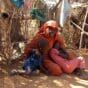 A woman and her two children in Zamzam camp, where she has sought shelter after fleeing attacks by the RSF in North Darfur. (AFP file photo)